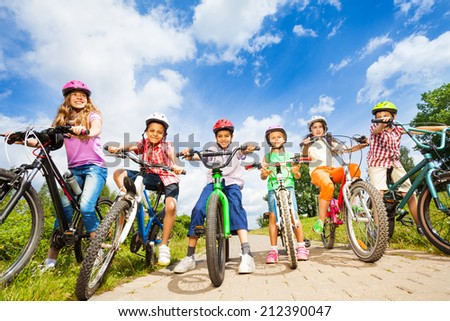 Below angle view of kids in helmets with bikes Royalty-Free Stock Photo #212390047