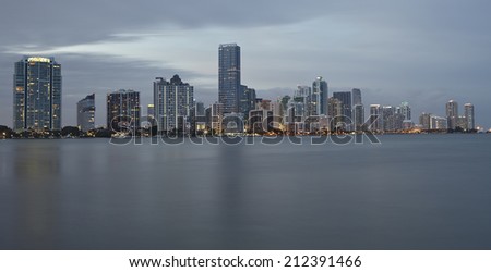 Miami city skyline panorama at sunset with urban skyscrapers with reflection