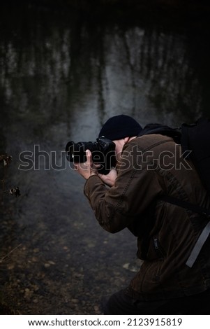 Male photographer taking a photo Royalty-Free Stock Photo #2123915819