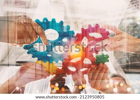 Business team connect pieces of gears like a teamwork and partners Royalty-Free Stock Photo #2123950805