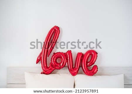 red love shape balloon at bedroom. Valentines concept Royalty-Free Stock Photo #2123957891