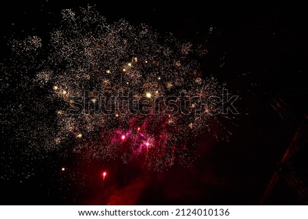 Fireworks sparks on a black sky background with copy space for text or inscriptions. A graphic resource for design. Blank for the designer. Underlay or undercoat.
