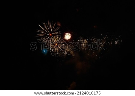 Very beautiful fireworks against the black sky with copy space for text or inscriptions. A graphic resource for design. Blank for the designer. Underlay or undercoat.