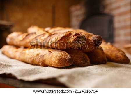 French organic baguettes bread in authentic bakery setting Royalty-Free Stock Photo #2124016754