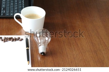 Work space to generate ideas, with coffee and pen