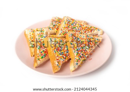 Traditional Australian fairy bread on plate isolated on white background.