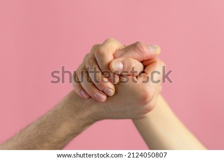 hands of man and woman in struggle for gender equality, female independence, male masculine power, confrontation. feminism concept. international womens day 8 march. arm wrestling
