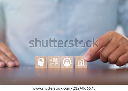 Hand puts wooden cubes with knowledge, skills, experience, performance and goals icon on grey background with .copy space. Banner competence, skills and knowledge concept. Royalty-Free Stock Photo #2124066575