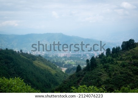 Far Away Cityscape of La Estrella Surrounded by Green Mountains