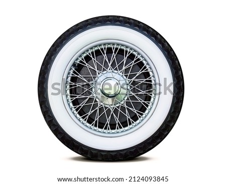 Antique chrome spoke wheel with white-faced rubber and center nut, isolated Royalty-Free Stock Photo #2124093845