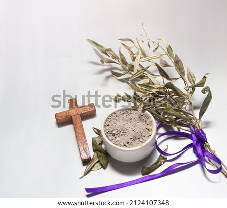 Bowl with ashes, olive branch and cross, symbols of Ash Wednesday Royalty-Free Stock Photo #2124107348