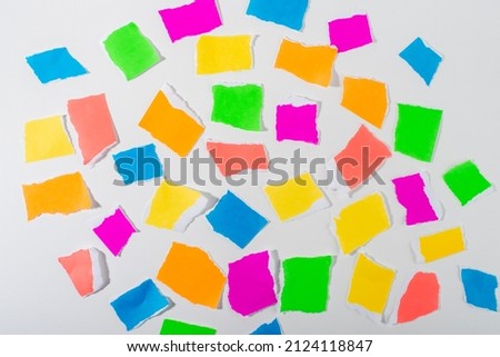 Neon colour torn paper pieces isolated on white background.