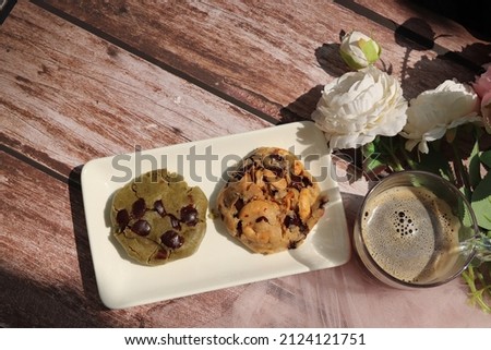 Homemade assorted brown butter cookies on white plate and wooden background. Top view food.