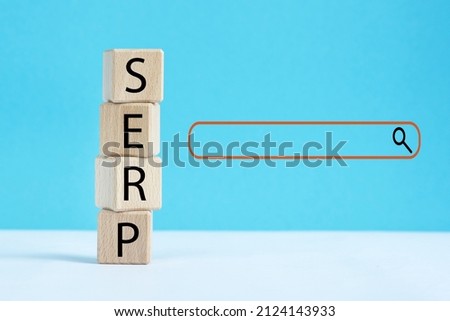 Wooden cubes with word SERP. marketing buzzword, acronym SERP. Search engine results page concept.