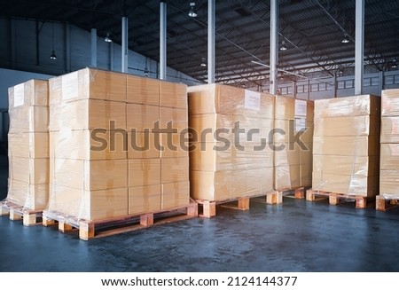 
Packaging Boxes Wrapped Plastic Film on Pallets in Storage Warehouse. Cartons Cardboard Boxes. Supply Chain. Storehouse Commerce Shipment. Shipping Warehouse Logistics.	
