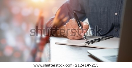 Close-up of man hand using writing pen memo on notebook paper or letter, diary on table desk office. Workplace for student, writer with copy space. business working and learning education concept. Royalty-Free Stock Photo #2124149213