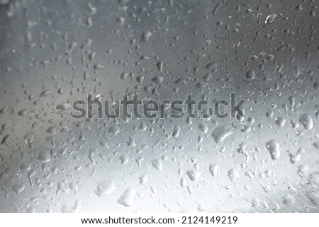 water droplets on a silver surface close-up