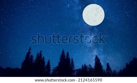 forest in silhouette with starry night sky and full moon