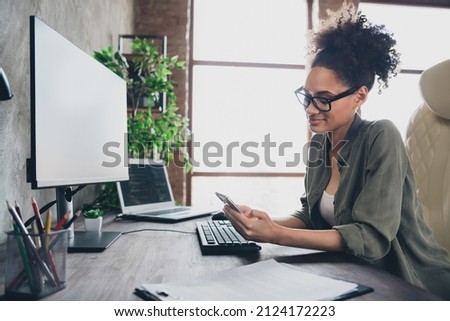 Profile side view portrait of attractive focused girl technician texting using device app remote support at workplace workstation indoors Royalty-Free Stock Photo #2124172223