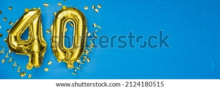 gold foil balloon number forty. Birthday or anniversary card with inscription 40. blue concrete background. Anniversary celebration. Banner. copy space