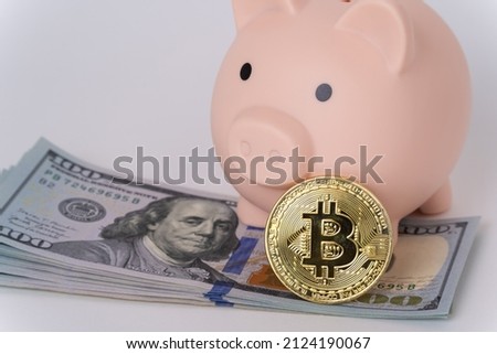Piggy bank with dollars and a bitcoin coin on a white background. The concept of investing in bitcoin, safe trading, retirement savings, account security.