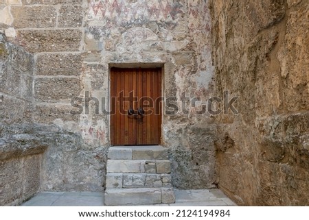 Old stone building and wooden door.  Interior of Aspendos Roman ancient theater. Old door.