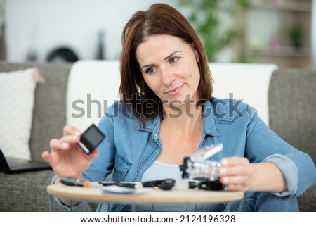 a woman fixing her camera