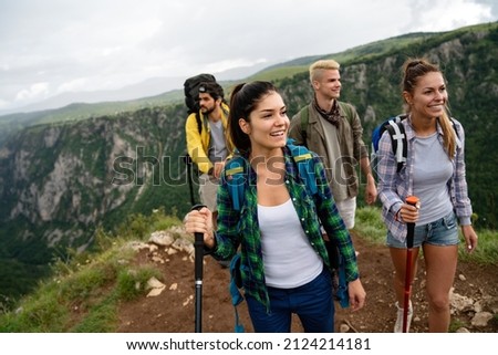 Group of happy hiker friends trekking as part of healthy lifestyle outdoors activity