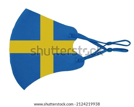 Blue cotton reusable cloth protective mask looks as flag of Sweden isolated on white background.
