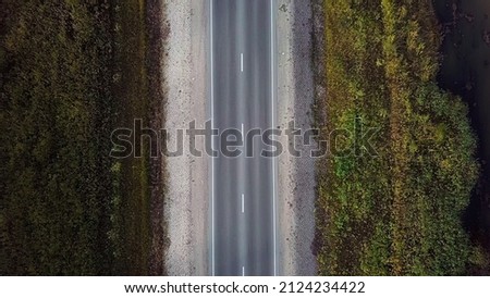 Aerial top view of country forest one-way road. Highway top down view.