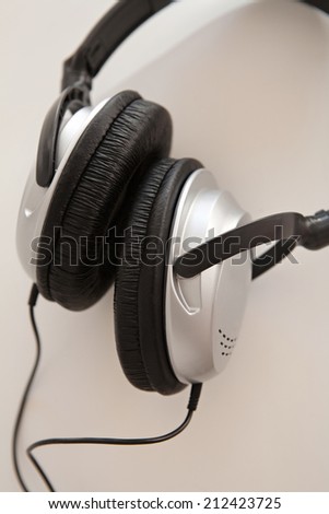 Close up still life detail of a pair of professional headphones isolated on a white background. Music and technology equipment objects, interior.