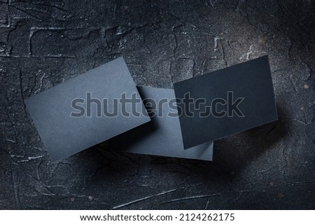 Black business card mock up on a dark background, a template for design presentation, thick cardboard visiting cards levitating on black