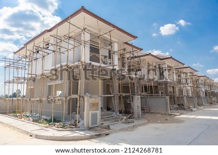 construction residential new house in progress at building site housing estate development Royalty-Free Stock Photo #2124268781