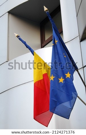 Romanian and European flag hanging of a building