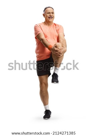 Mature man in sportswear stretching his leg isolated on white background Royalty-Free Stock Photo #2124271385