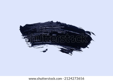 Photo of black mascara for eye lashes texture background isolated on white