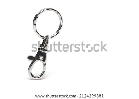 Close up of silver metal keychain in shape of carabiner on white background Royalty-Free Stock Photo #2124299381