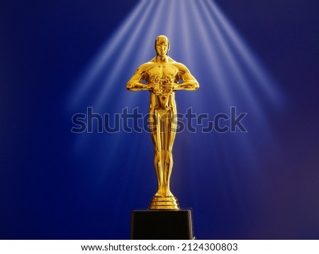 Hollywood Golden Oscar Academy award statue on red background. Success and victory concept. Royalty-Free Stock Photo #2124300803