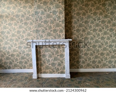Old vintage wall with wallpaper and fireplace