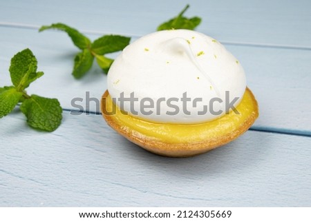lemon meringue pie isolated on a white background with fresh mint