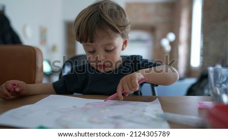 Child drawing with color pen on paper Little boy playing art and craft