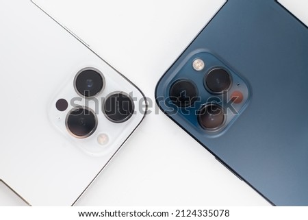 a white smartphone with three cameras lies on a  white background Royalty-Free Stock Photo #2124335078