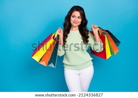 Photo of nice young brunette lady with bag look promo wear green sweater isolated on blue color background