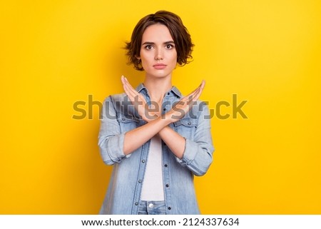 Photo of young pretty serious woman crossed hands show no stop forbidden symbol isolated over yellow color background Royalty-Free Stock Photo #2124337634