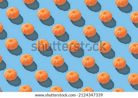 Peeled mandarin repeated seamless pattern on blue backdrop