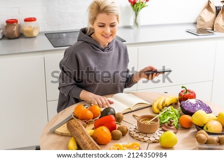Woman using calorie counter application on her smartphone