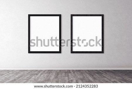 Two white empty posters with black wooden frame on wall.