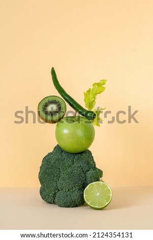 Fresh green vegetables and fruits balancing on the table. Equilibrium floating food balance