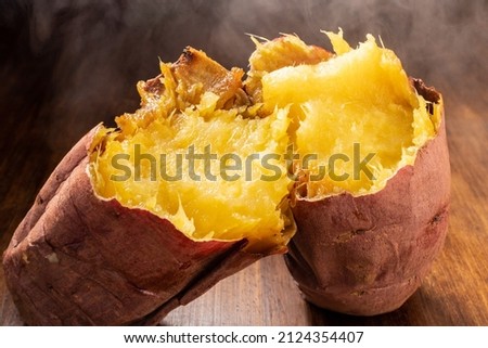 Roasted sweet potato split in two Royalty-Free Stock Photo #2124354407