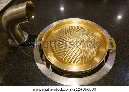 Brass grill pan placed on the gas stove Royalty-Free Stock Photo #2124356033